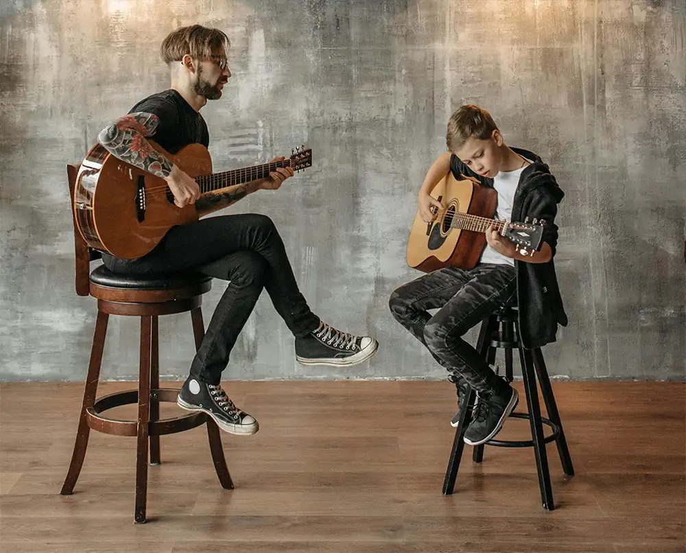 Two musicians playing guitar