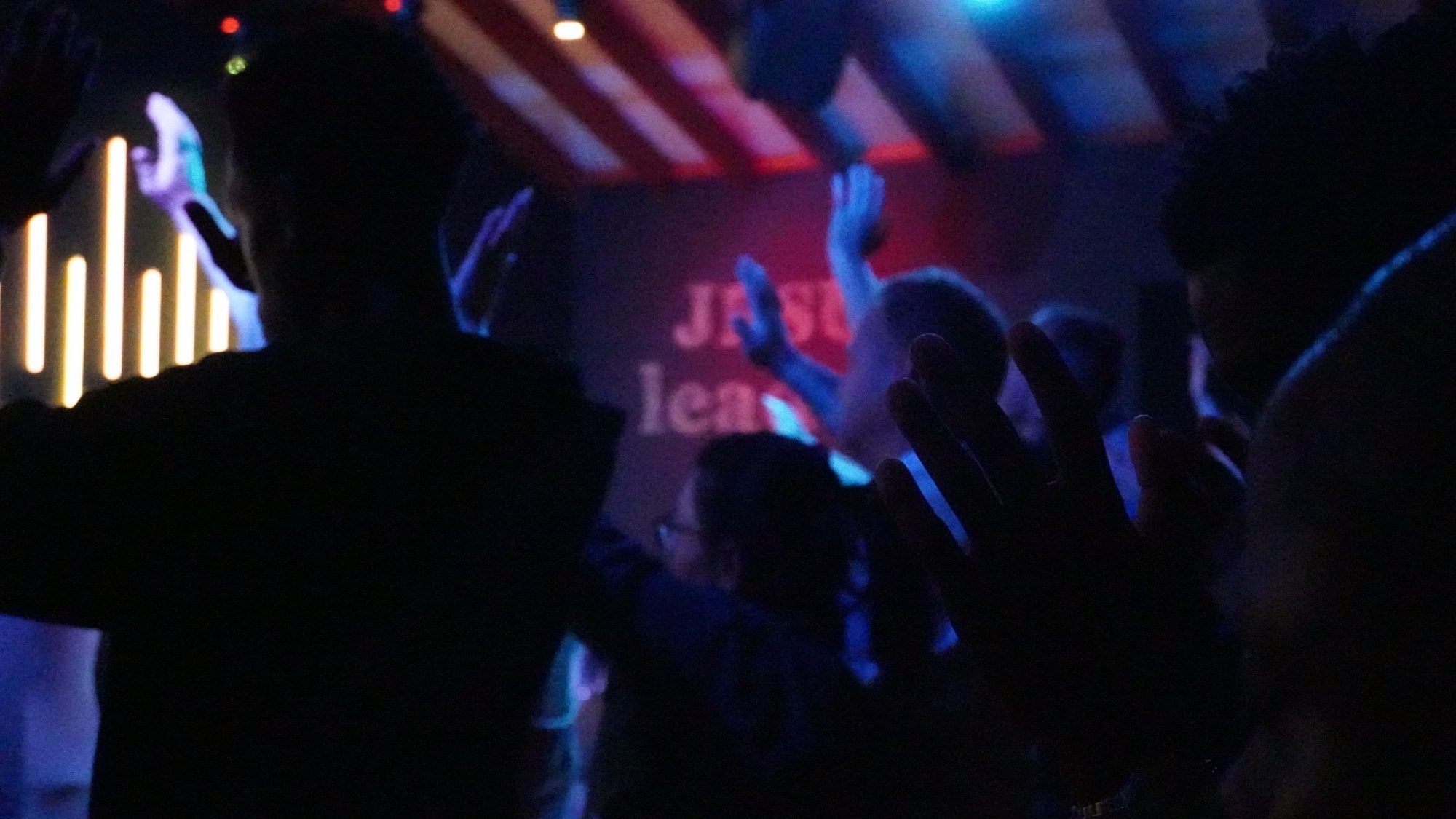 A congregation worshipping with hands raised